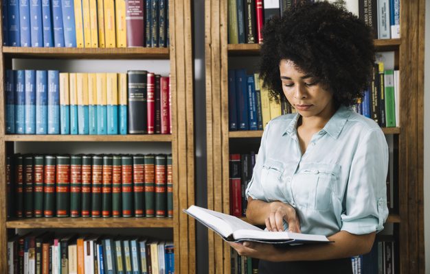 black-woman-reading-book-library_23-2148042693